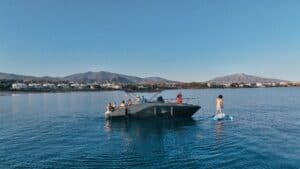 A customer enjoying a SUP board next to a boat